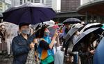 雨が降る中、政党の街頭演説に耳を傾ける人たち＝１７日午後、東京・有楽町